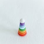 Brightly colored stacking toy on a white background, symbolizing fun and learning.